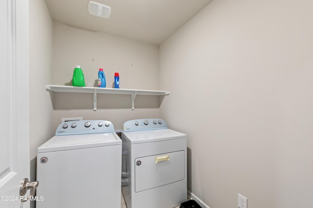 clothes washing area featuring washer and clothes dryer