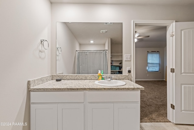 bathroom featuring ceiling fan, vanity, and tile patterned floors