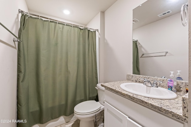 bathroom featuring curtained shower, tile patterned flooring, vanity, and toilet