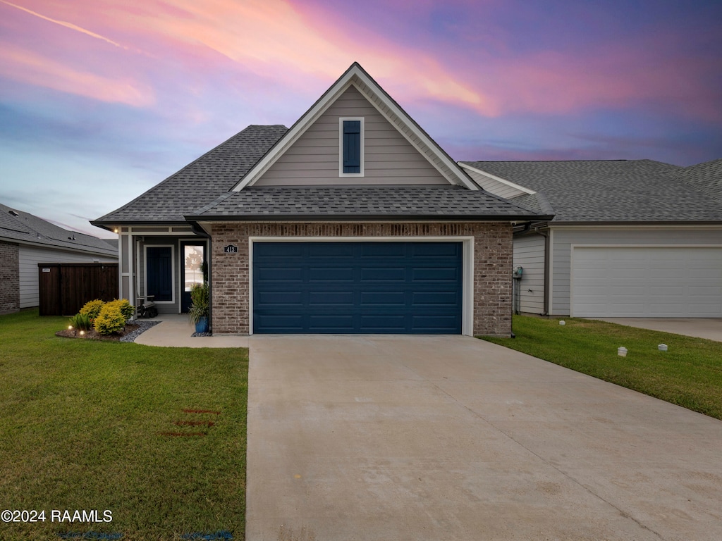 view of front facade featuring a lawn and a garage