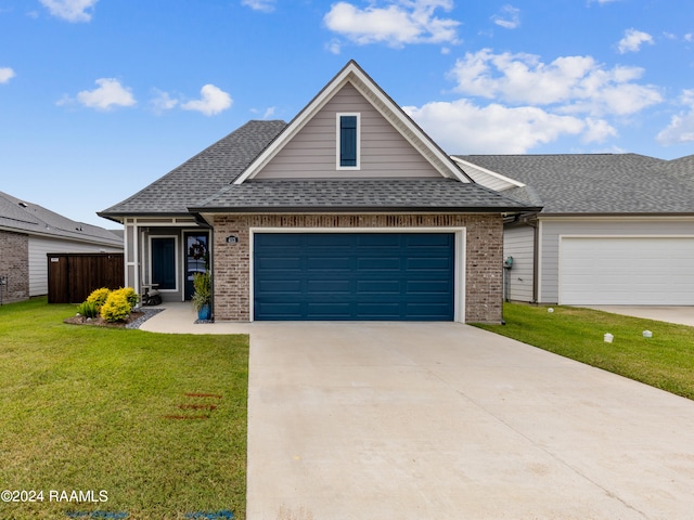 view of front of property featuring a garage and a front yard