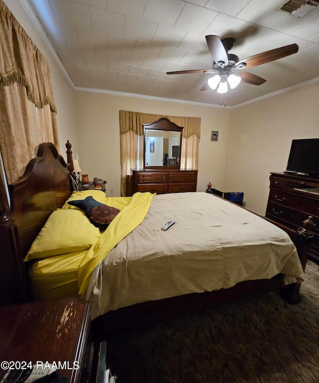 bedroom with ornamental molding, carpet, and ceiling fan