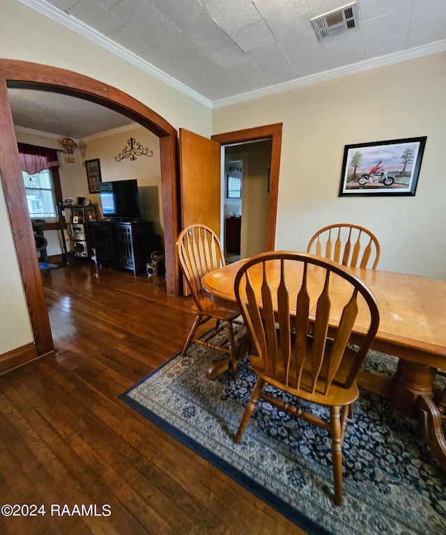 dining room featuring a textured ceiling, crown molding, and dark hardwood / wood-style floors