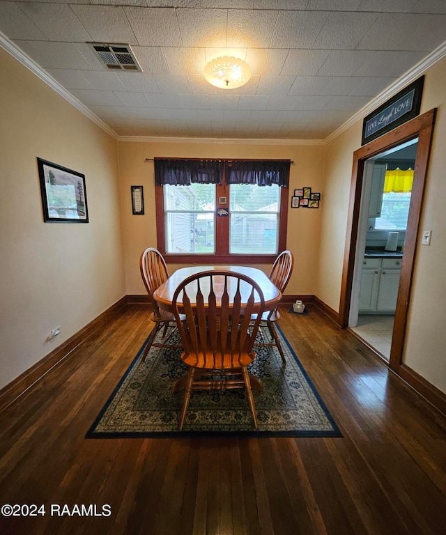 dining room featuring crown molding and dark hardwood / wood-style flooring