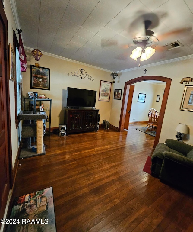 living room with ornamental molding, dark hardwood / wood-style floors, and ceiling fan