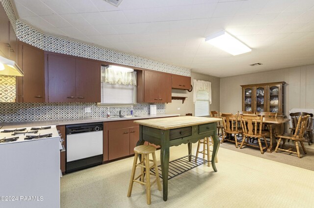 14311 William Rd, Kaplan, LA 70548 - kitchen featuring light carpet, a healthy amount of sunlight, a sink, and white dishwasher