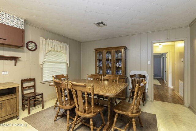 14311 William Rd, Kaplan, LA 70548 - dining room with a decorative wall, ornamental molding, visible vents, and light floors