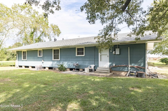 14311 William Rd, Kaplan, LA 70548 - rear view of house featuring a yard, roof with shingles, and entry steps