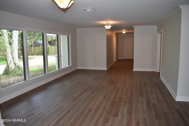 spare room featuring crown molding and dark hardwood / wood-style flooring