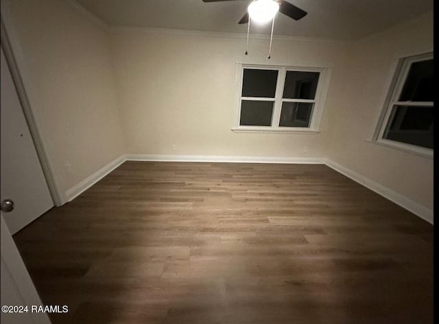 empty room featuring crown molding, wood-type flooring, and ceiling fan