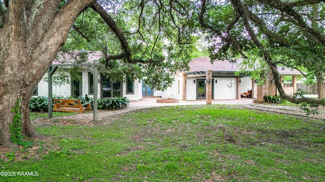 2862 S Union St, Opelousas, LA 70570 - rear view of house with a pergola, a patio area, and a lawn