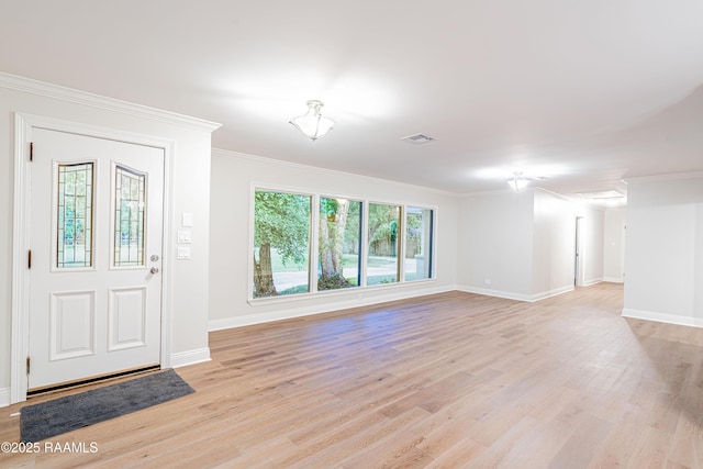 2862 S Union St, Opelousas, LA 70570 - foyer entrance with light wood finished floors, baseboards, and crown molding