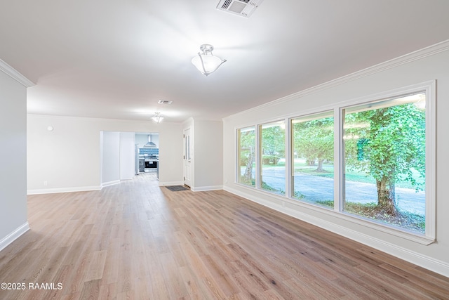 2862 S Union St, Opelousas, LA 70570 - unfurnished living room with baseboards, light wood finished floors, ornamental molding, and a glass covered fireplace