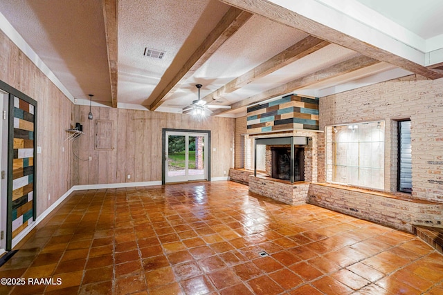 2862 S Union St, Opelousas, LA 70570 - unfurnished living room featuring beam ceiling, a ceiling fan, tile patterned floors, a brick fireplace, and baseboards