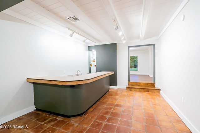 2862 S Union St, Opelousas, LA 70570 - bar area featuring rail lighting, baseboards, and beam ceiling