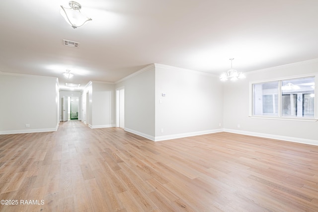 2862 S Union St, Opelousas, LA 70570 - spare room featuring light wood-style floors, a chandelier, baseboards, and crown molding