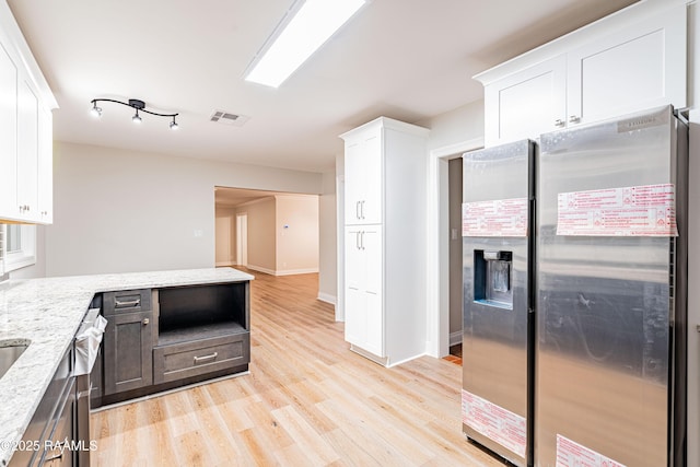 2862 S Union St, Opelousas, LA 70570 - kitchen featuring stainless steel appliances, white cabinets, light wood-type flooring, and light stone counters