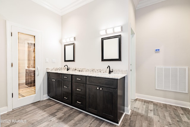 2862 S Union St, Opelousas, LA 70570 - full bath featuring wood finished floors, crown molding, baseboards, double vanity, and a shower