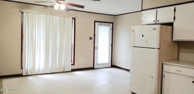 kitchen with ornamental molding, white cabinets, ceiling fan, and white refrigerator