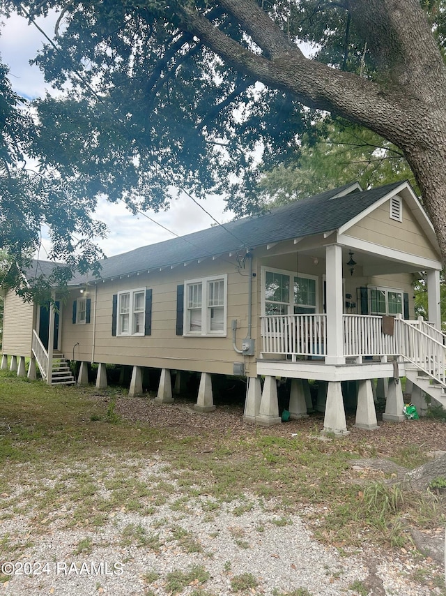 rear view of house featuring covered porch