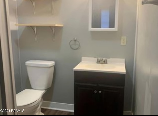 bathroom featuring hardwood / wood-style floors, vanity, and toilet