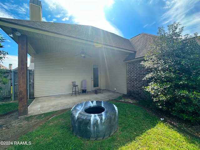 rear view of property featuring a yard and a patio