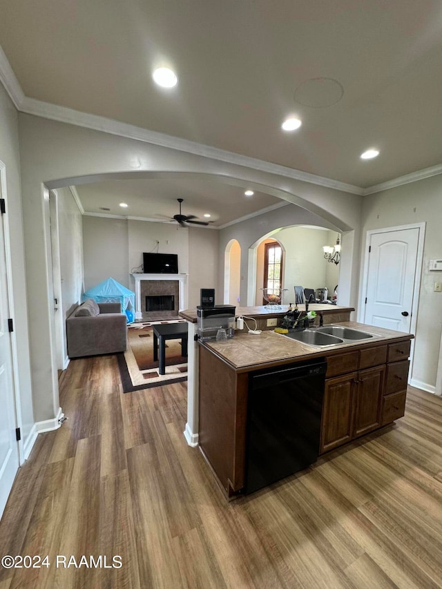 kitchen with an island with sink, dark brown cabinets, black dishwasher, and hardwood / wood-style flooring