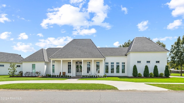 view of front of home with covered porch and a front yard