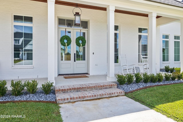 view of exterior entry with a porch