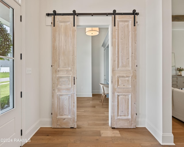 interior space featuring light hardwood / wood-style flooring and a barn door