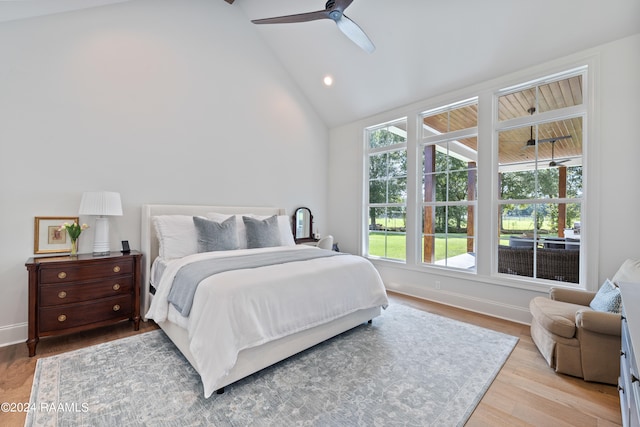 bedroom with vaulted ceiling, ceiling fan, and light hardwood / wood-style flooring