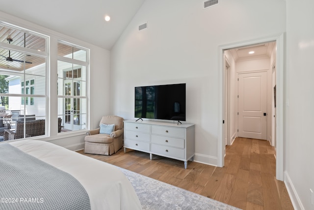 bedroom featuring light hardwood / wood-style flooring and high vaulted ceiling