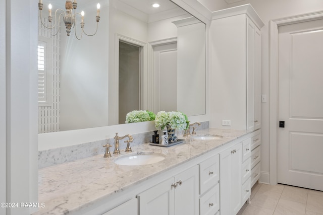 bathroom with an inviting chandelier, tile patterned flooring, and vanity