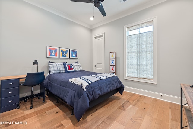 bedroom featuring ornamental molding, light wood-type flooring, and ceiling fan