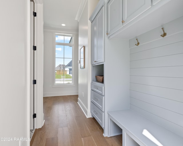 mudroom featuring light hardwood / wood-style flooring and ornamental molding