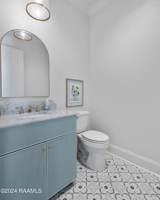 bathroom with tile patterned flooring, vanity, and toilet