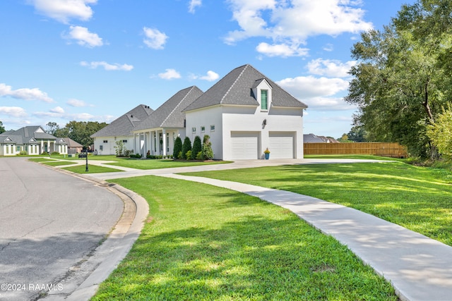 french country inspired facade with a garage and a front lawn