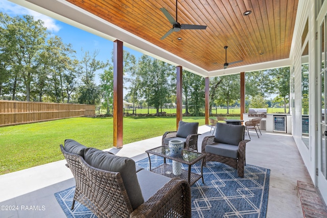 view of patio featuring wine cooler, a grill, an outdoor kitchen, outdoor lounge area, and ceiling fan