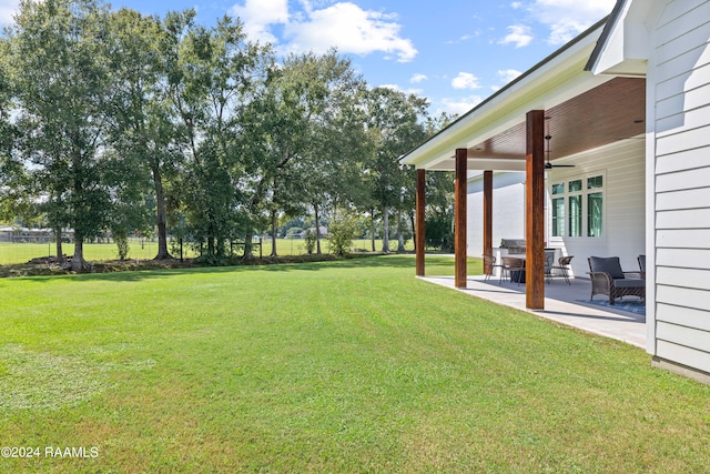 view of yard featuring a patio and ceiling fan