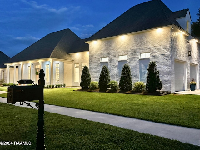 view of front of house with a garage and a front lawn