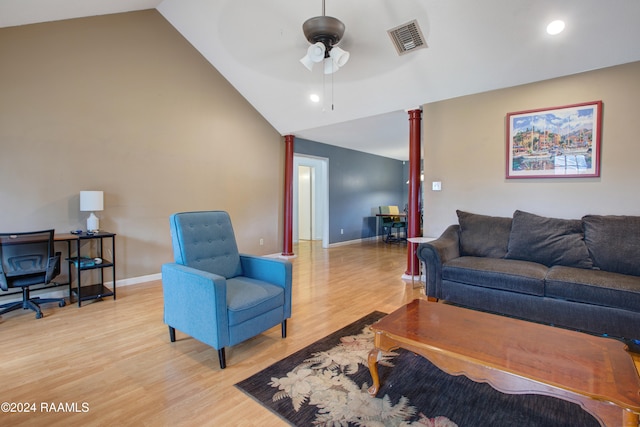 living room with ceiling fan, lofted ceiling, and light wood-type flooring