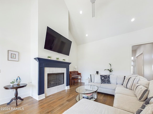 living room featuring ceiling fan, high vaulted ceiling, and hardwood / wood-style floors