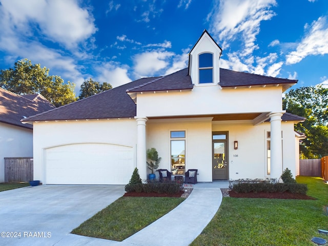 view of front of home featuring a front lawn and a garage