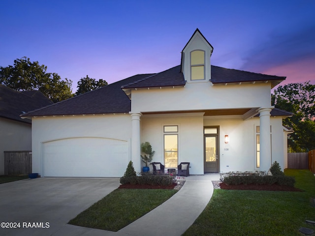 view of front of house with a lawn and a garage