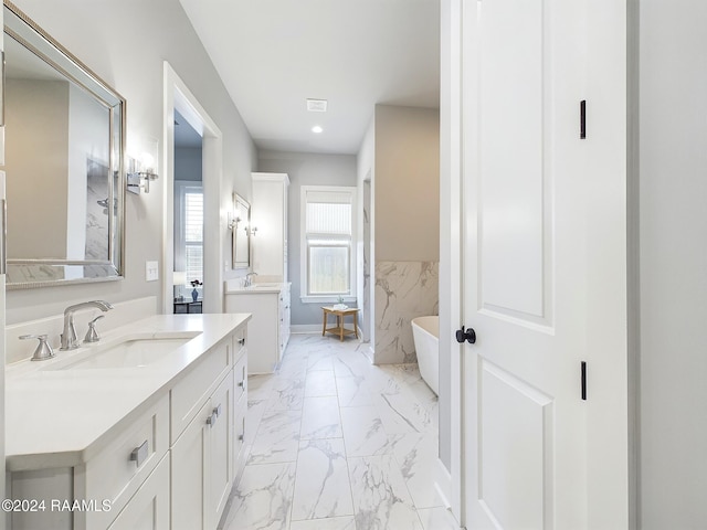 102 Blue Harbor Ln, Lafayette, LA 70503 - full bath featuring marble finish flooring, a soaking tub, two vanities, recessed lighting, and baseboards