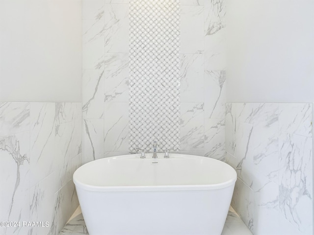 bathroom with tile walls and a bathing tub