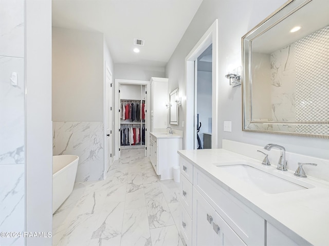 bathroom with vanity and a bathtub