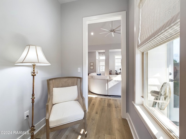 sitting room featuring ceiling fan and hardwood / wood-style floors