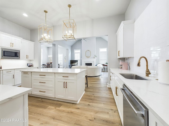 kitchen with white cabinetry, stainless steel appliances, and sink