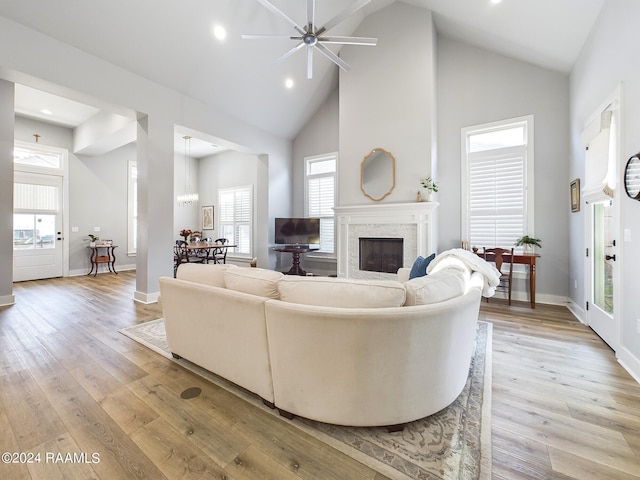 102 Blue Harbor Ln, Lafayette, LA 70503 - living room featuring high vaulted ceiling, a fireplace, light wood-style floors, baseboards, and a ceiling fan